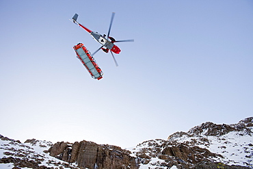 A Navy Sea King helicopter lowers a stretcher to evacuate a seriously injured walker who had fallen 250 feet on Bow Fell in the Lake District, Cumbria, England, United Kingdom, Europe