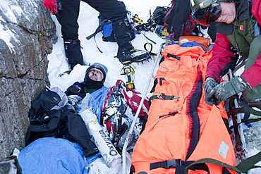 A Navy Sea King helicopter crew and mountain rescue team members treat a seriously injured walker who had fallen 250 , Cumbria, England, United Kingdom, Europe