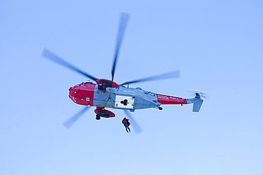 A Navy Sea King helicopter lowers a stretcher to evacuate a seriously injured walker who had fallen 250 feet on Bow Fell in the Lake District, Cumbria, England, United Kingdom, Europe