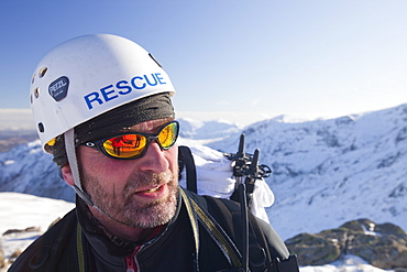 Members of Langdale Ambleside Mountain Rescue Team descend Bow Fell after treating and evacuating a seriously injured climber in the Lake District, Cumbria, England, United Kingdom, Europe