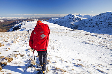 Members of Langdale Ambleside Mountain Rescue Team descend Bow Fell after treating and evacuating a seriously injured climber in the Lake District, Cumbria, England, United Kingdom, Europe