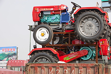 A lorry loaded with cheap new tractors in northern China, Asia