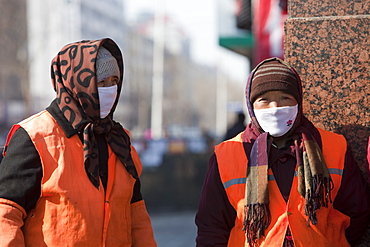 Road sweepers wear a face masks against the awful air pollution in Harbin city, Heilongjiang, Northern China, Asia