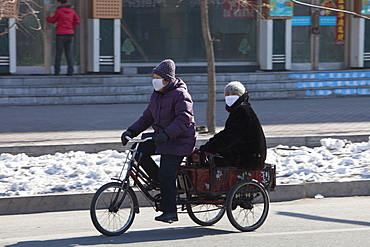 People wear face masks against the awful air pollution in Suihua city, Heilongjiang, Northern China, Asia