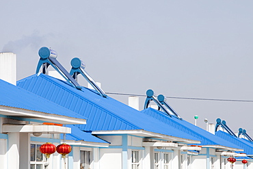 Solar water heaters on roofs of housing complex in Heilongjiang province, Northern China, Asia