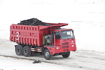 Trucks haul highly polluting low grade coal from an open cast coal mine near Heihe, Heilongjiang province on the Chinese Russian border, China, Asia