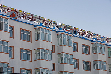 Solar water heaters on roofs of housing complex in Heilongjiang province, Northern China, Asia