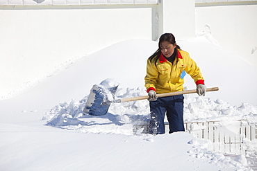 Workers in Heihe on the Chinese Russian border shovel heavy snow from the worst snowstorm to hit northern China in March for many years, Heilongjiang province, China, Asia