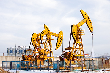 Nodding donkey oil pumps pumping oil up from the Daqing oil field in Northern China, Asia