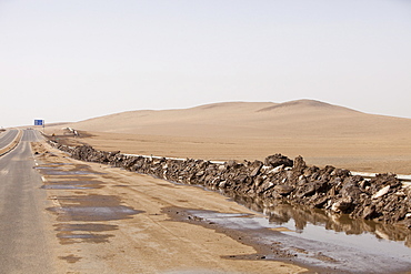 Sand dunes spreading across a highway in Inner Mongolia, China, Asia