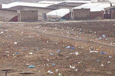 Plastic rubbish blows across the desert landscape of Inner Mongolia, China, Asia