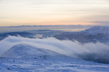 An approaching storm front coming over the Lakeland fells from the west taken from the summit of Fairfield in the Lake District, Cumbria, England, United Kingdom, Europe