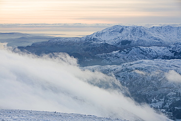 An approaching storm front coming over the Lakeland fells from the west taken from the summit of Fairfield in the Lake District, Cumbria, England, United Kingdom, Europe