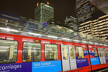 Docklands Light Railway with banking and financial sector buildings at Canary Wharf behind, Docklands, London, England, United Kingdom, Europe