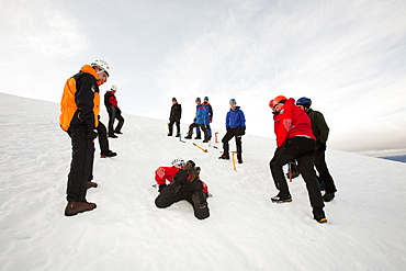 A group of mountaineers practise ice axe arrests on Cairngorm in the Cairngorm National Park in Scotland, United Kingdom, Europe