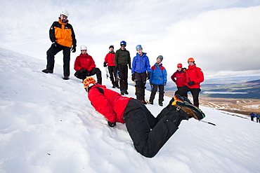 A group of mountaineers practise ice axe arrests on Cairngorm in the Cairngorm National Park in Scotland, United Kingdom, Europe