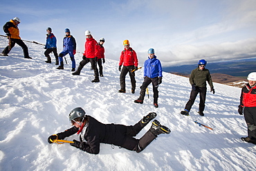 A group of mountaineers practise ice axe arrests on Cairngorm in the Cairngorm National Park in Scotland, United Kingdom, Europe