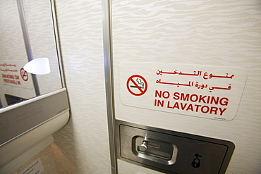 A no smoking sign in an airplane toilet