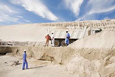 Arab workers working on a reclamation scheme to build another exclusive hotel resort on what was formerly seabed in Dubai, United Arab Emirates, Middle East