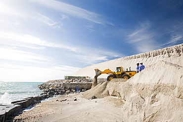 Arab workers working on a reclamation scheme to build another exclusive hotel resort on what was formerly seabed in Dubai, United Arab Emirates, Middle East