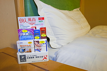 Condoms and other sex products in a bedside dispenser in a hotel in China, Asia