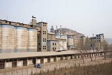 A coal fired cement factory billows smoke in Tongshuan, Shanxi Province, China, Asia