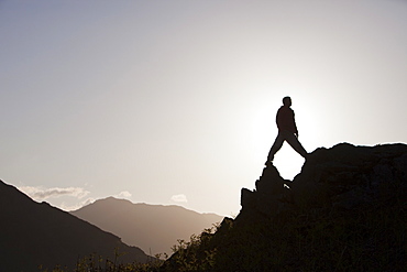 A climber on a ridge above Chapel Stile in the Langdale Valley in the Lake District, Cumbria, England, United Kingdom, Europe