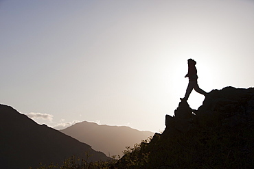 A climber on a ridge above Chapel Stile in the Langdale Valley in the Lake District, Cumbria, England, United Kingdom, Europe