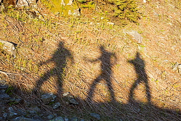 The shadows of three walkers in the Lake District, Cumbria, England, United Kingdom, Europe