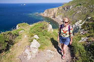 A woman on the South West coast Path near Cape Cornwall, Cornwall, England, United Kingdom, Europe