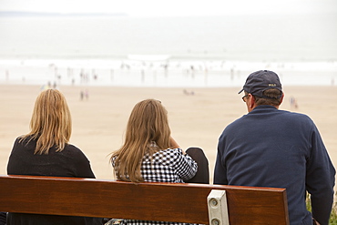 Watching surfers on Woolacombe beach, Devon, England, United Kingdom, Europe