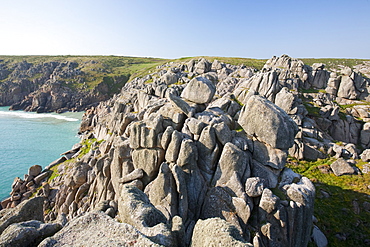 Granite sea cliffs at Logan Rock Headland in Porthcurno, Cornwall, England, United Kingdom, Europe