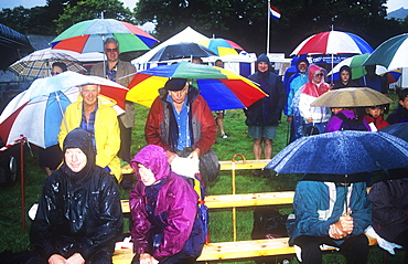 Spectators at the Ambleside Sports in the rain, Lake District, Cumbria, England, United Kingdom, Europe