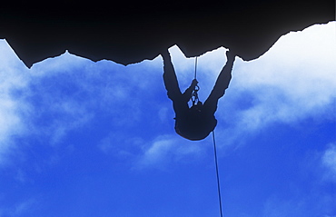 A man abseiling down a cliff in the Lake District, Cumbria, England, United Kingdom, Europe