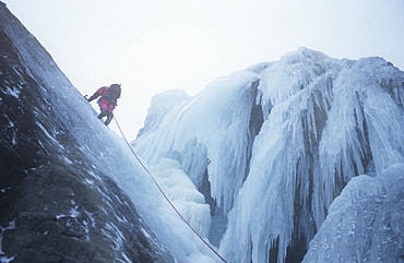 A mountaineer ice climbing on Low Water Beck, Coniston, Lake District, Cumbria, England, United Kingdom, Europe