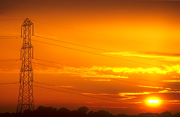 Sunset behind an electricity pylon in Cumbria, England, United Kingdom, Europe