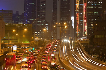 Office blocks lit up at night and cars in Hong Kong, China, Asia