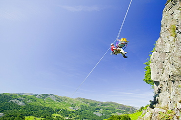 Members of Langdale Ambleside Mountain Rescue Team doing a stretcher lower down a crag in Langdale as part of training. Cumbria, England, United Kingdom, Europe