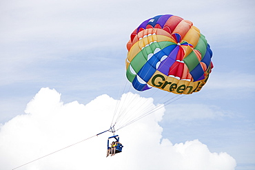 Tourists parasailing off Green Island on The Great Barrier Reef near Cairns in Queensland, Australia, Pacific