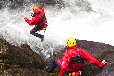 Members of the Langdale Ambleside Mountain Rescue Team train in Swift water rescue techniques on the River Brathay at Skelwyth, Lake District, Cumbria, England, United Kingdom, Europe