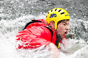 Members of the Langdale Ambleside Mountain Rescue Team train in Swift water rescue techniques on the River Brathay at Skelwyth, Lake District, Cumbria, England, United Kingdom, Europe