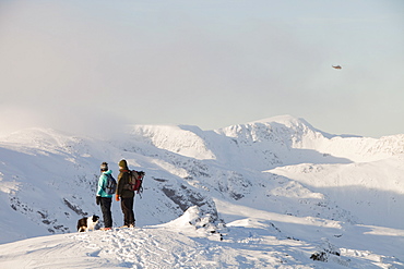 Walkers on the summit of Red Screes with the Helvellyn range behind, Lake District, Cumbria, England, United Kingdom, Europe