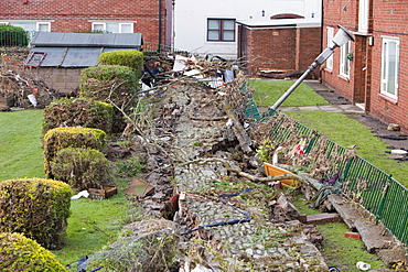 Walls knocked over by the pressure of flood water near Cockermouth's Main street, after the water receded, Cumbria, England, United Kingdom, Europe