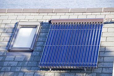 Solar water heating panels on a house roof in Polruan in Cornwall, England, United Kingdom, Europe