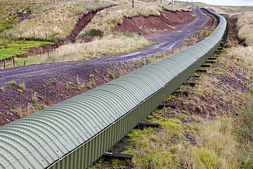 A conveyor belt taking coal from the Glentaggart open cast coal mine to a roadhead for onward transport by road in Lanarkshire, Scotland, United Kingdom, Europe