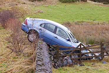 A crashed car after it careered off the road in the floods near Keswick, Lake District, Cumbria, England, United Kingdom, Europe