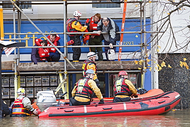 Rescue workers rescuing flood victims from their houses on the Main Street of Cockermouth, Cumbria, England, United Kingdom, Europe