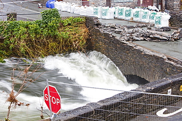 The flooding River Leven that empties Lake Windermere, swept the parapets off the bridge at Backbarrow, resulting in its closure, Cumbria, England, United Kingdom, Europe