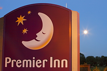 A Premier Inn sign and moon at night