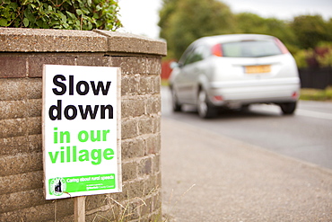 A sign asking motorists to slow down in Mundesley village in Norfolk, England, United Kingdom, Europe